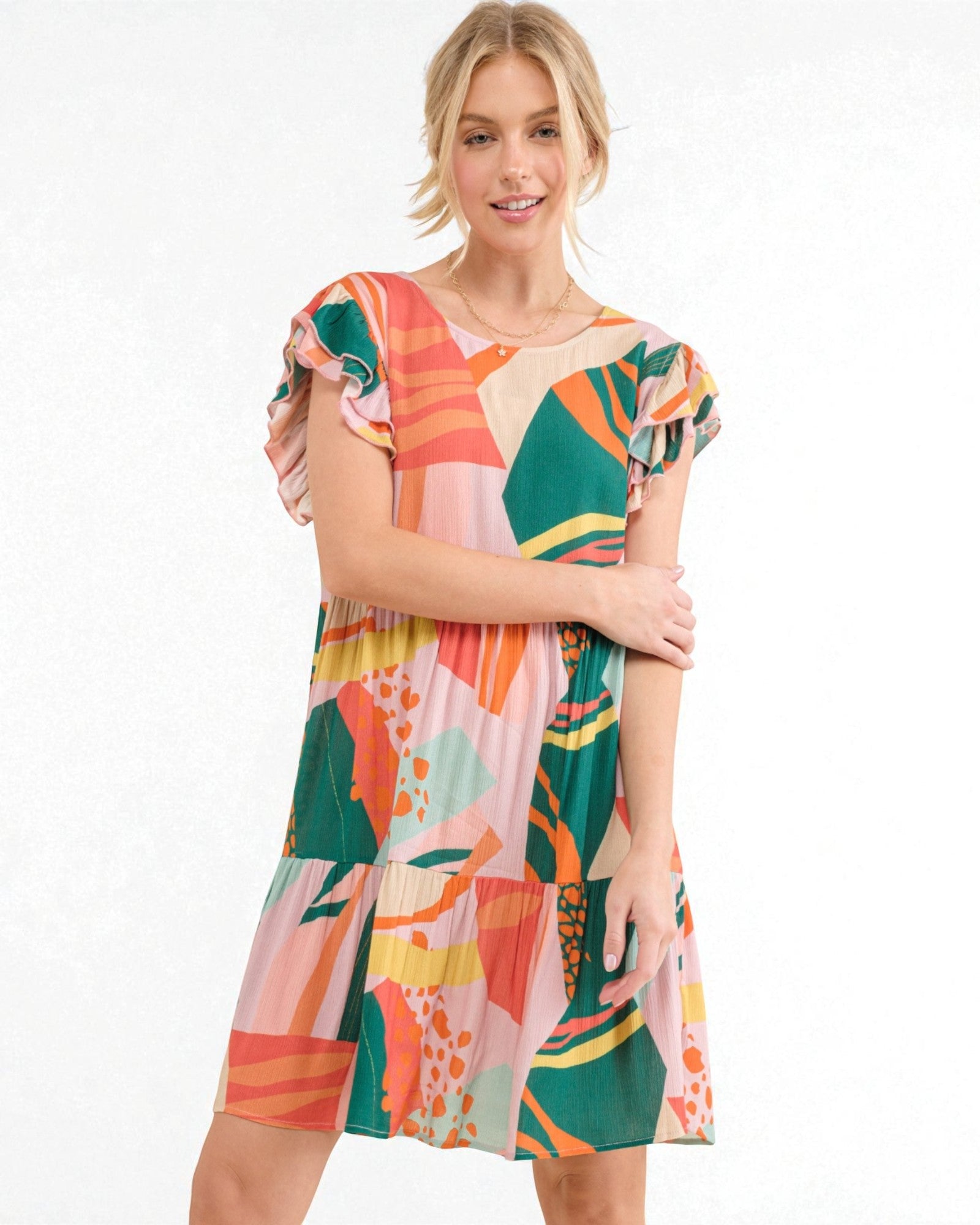 Woman wearing a colorful patterned dress on a white background