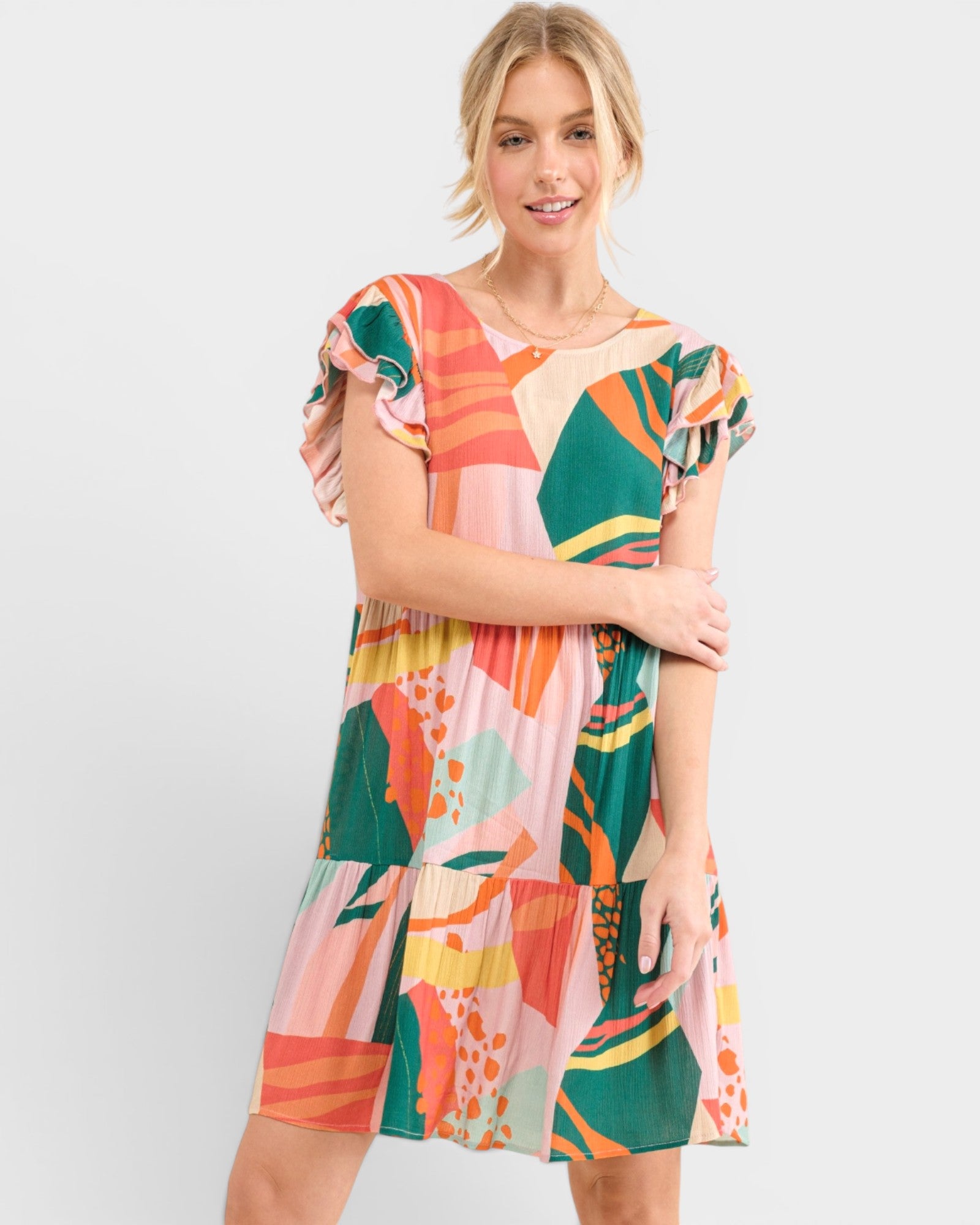 Woman wearing a colorful patterned dress on a white background
