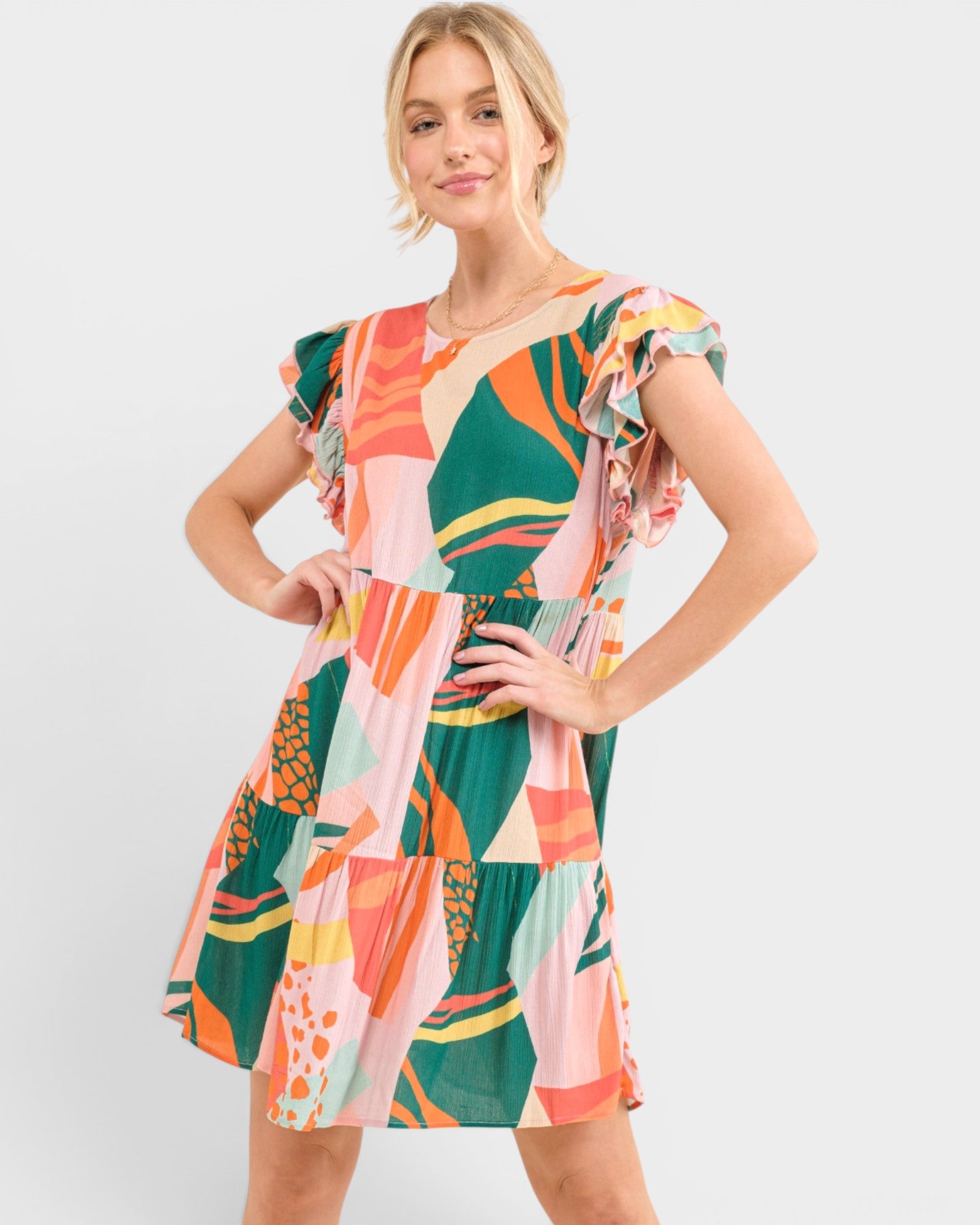 Woman wearing a colorful patterned dress on a white background
