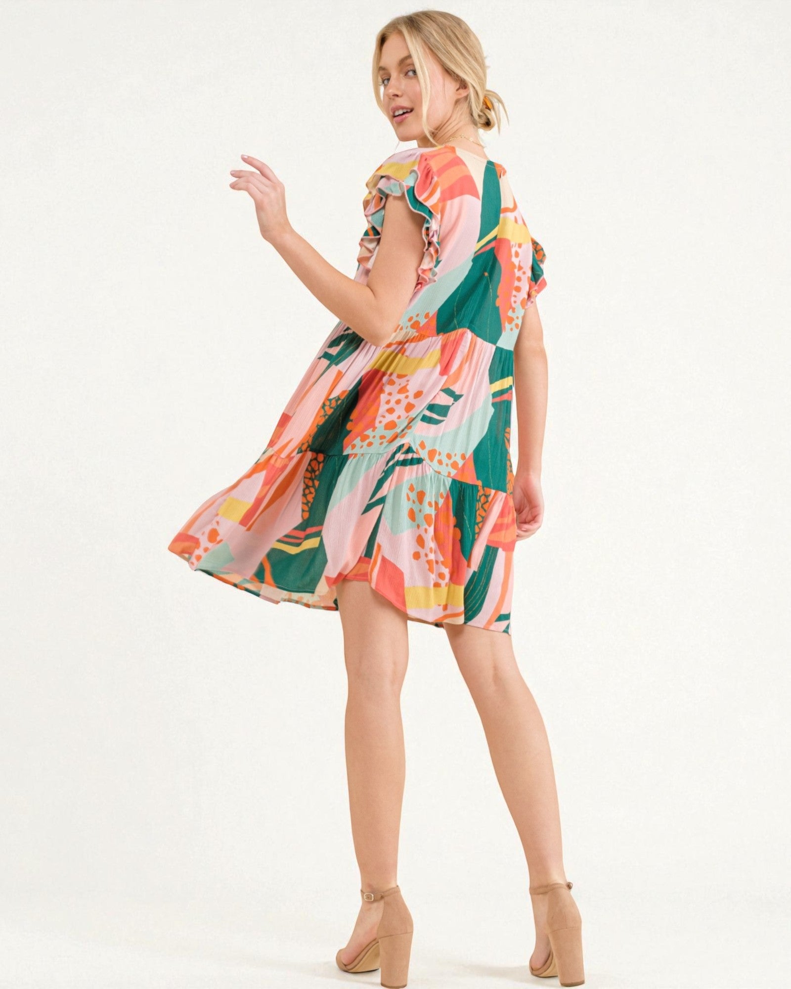 Woman wearing a colorful patterned dress on a white background