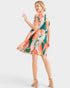 Woman wearing a colorful patterned dress on a white background