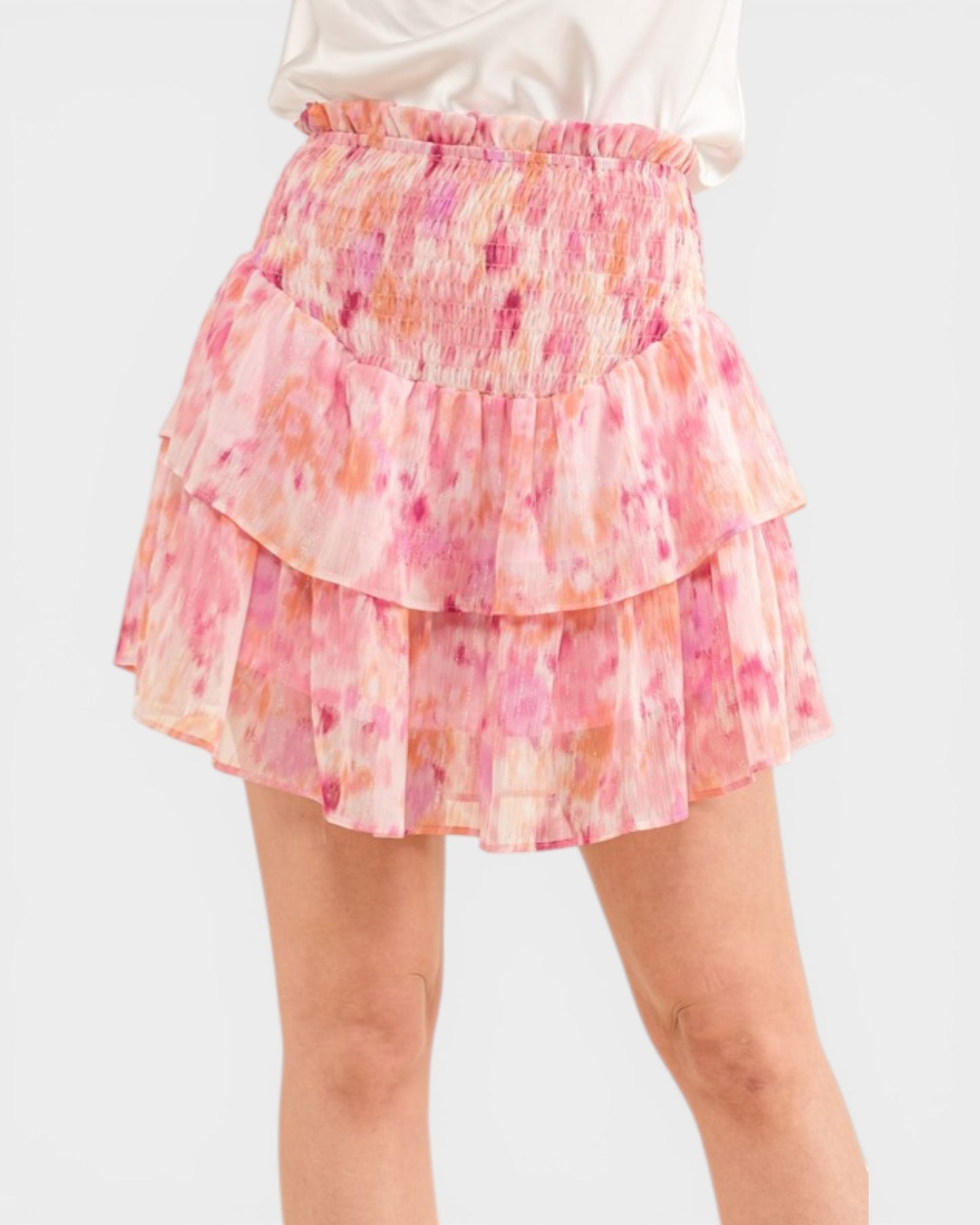 Pink floral tiered skirt on a white background