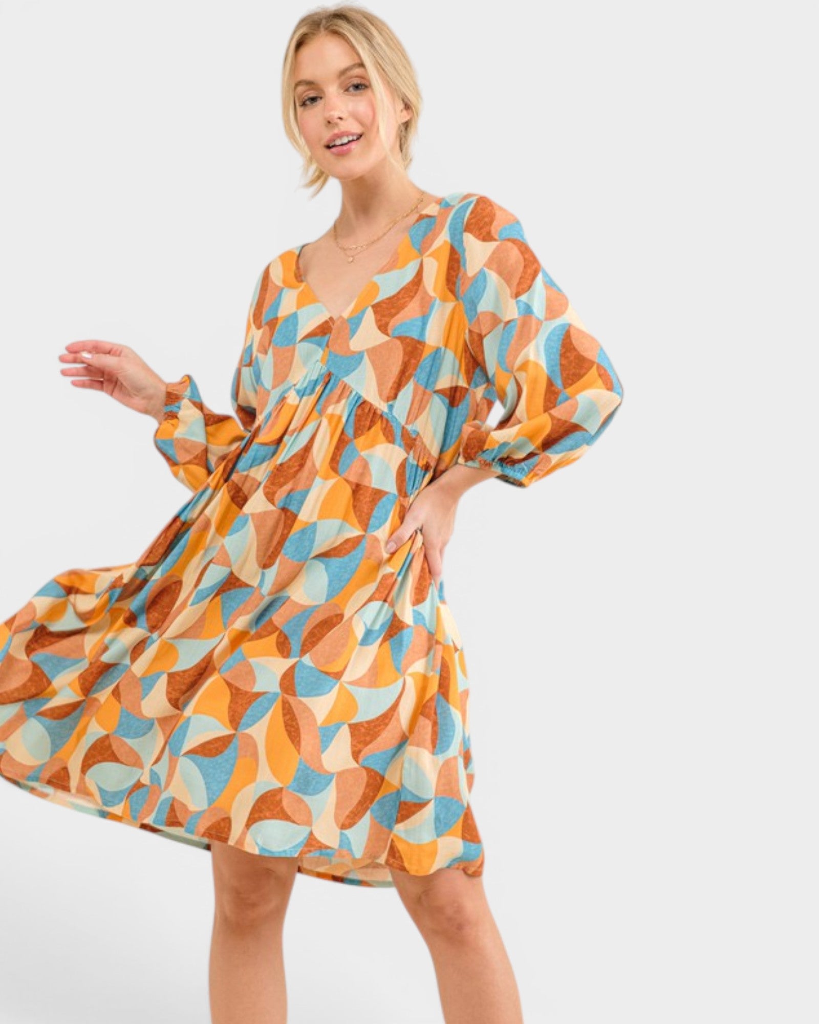 Woman wearing a colorful patterned dress on a white background