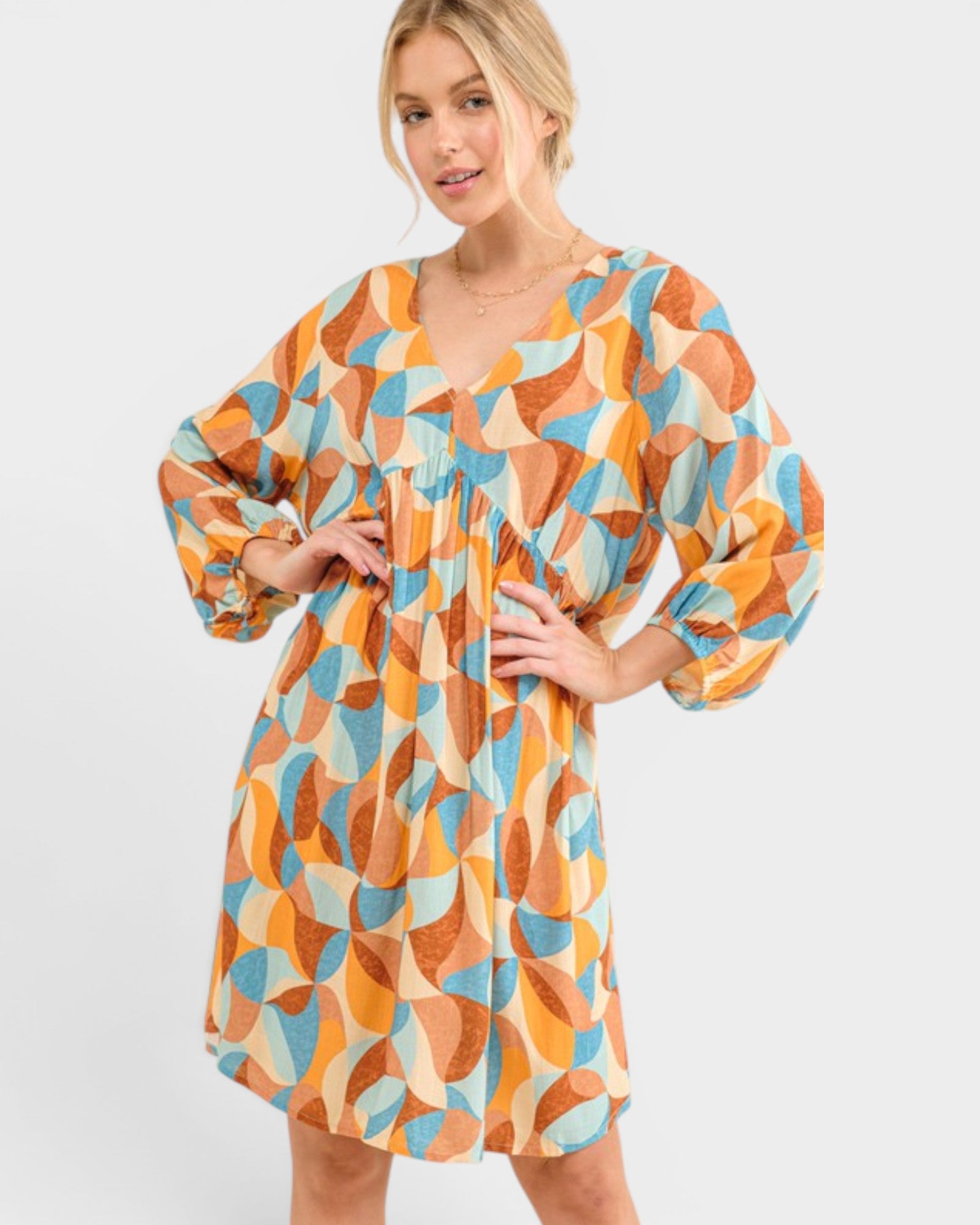 Woman wearing a colorful patterned dress on a white background