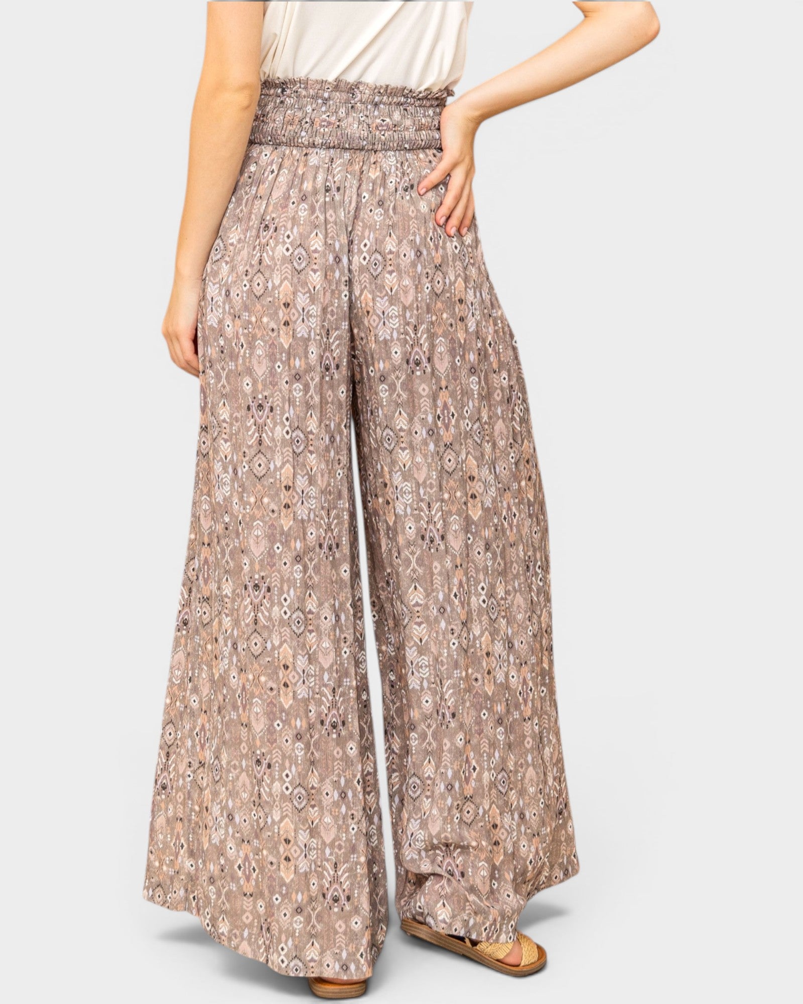 Patterned wide-leg pants worn by a person on a plain background