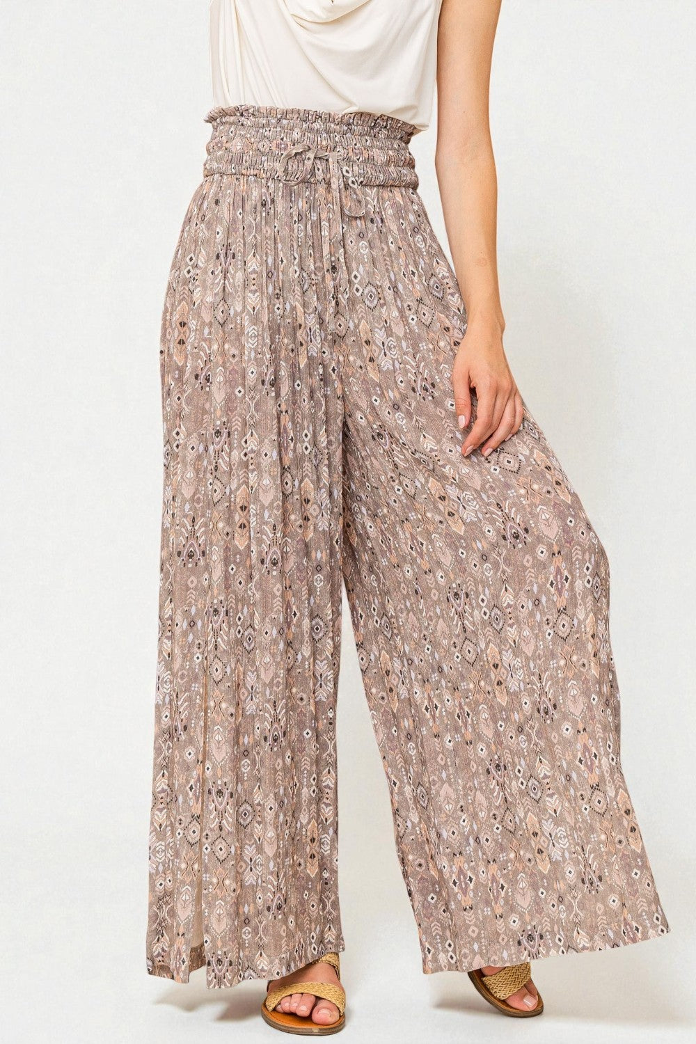 Floral patterned wide-leg pants worn by a person on a white background