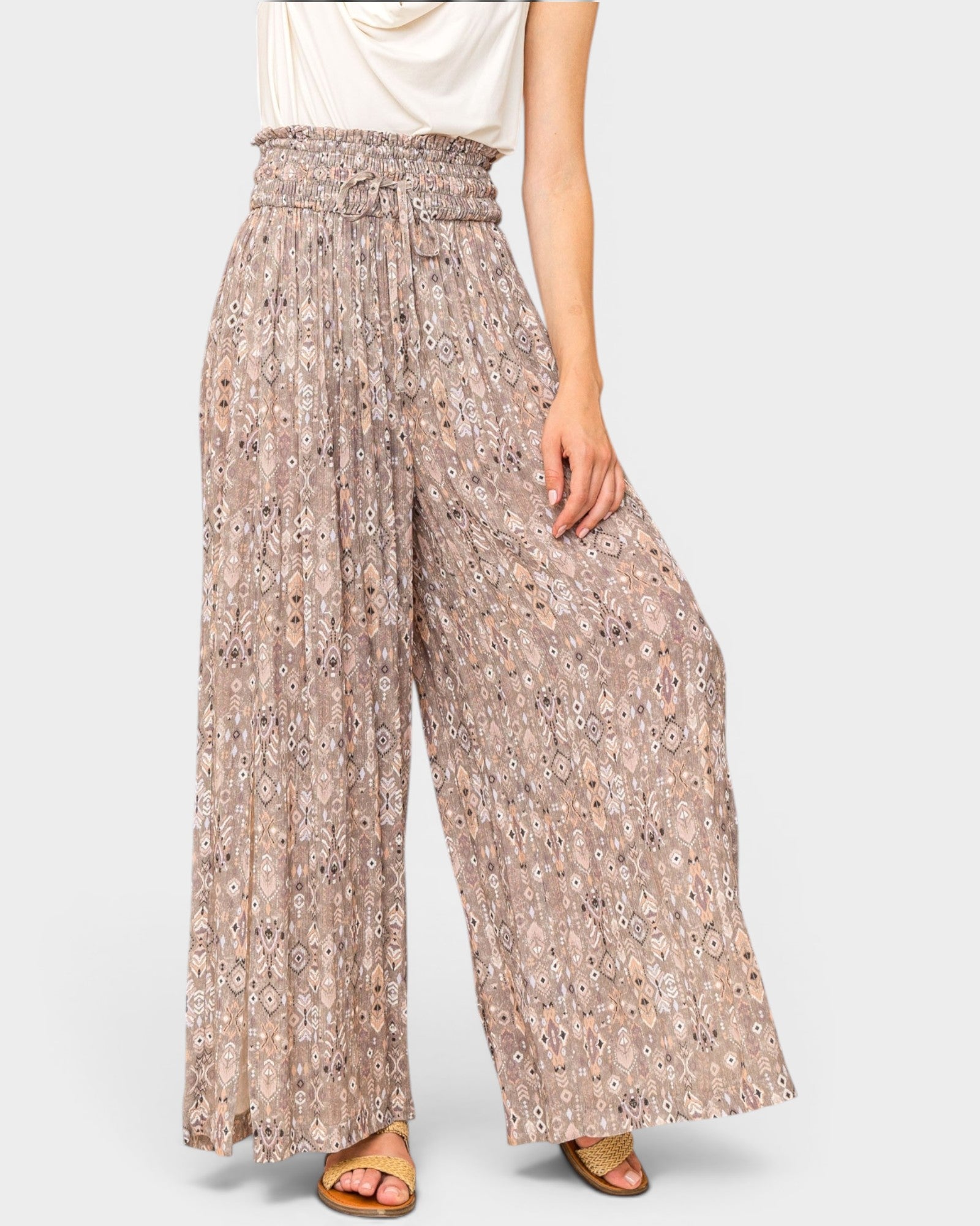Floral patterned wide-leg pants worn by a person on a white background