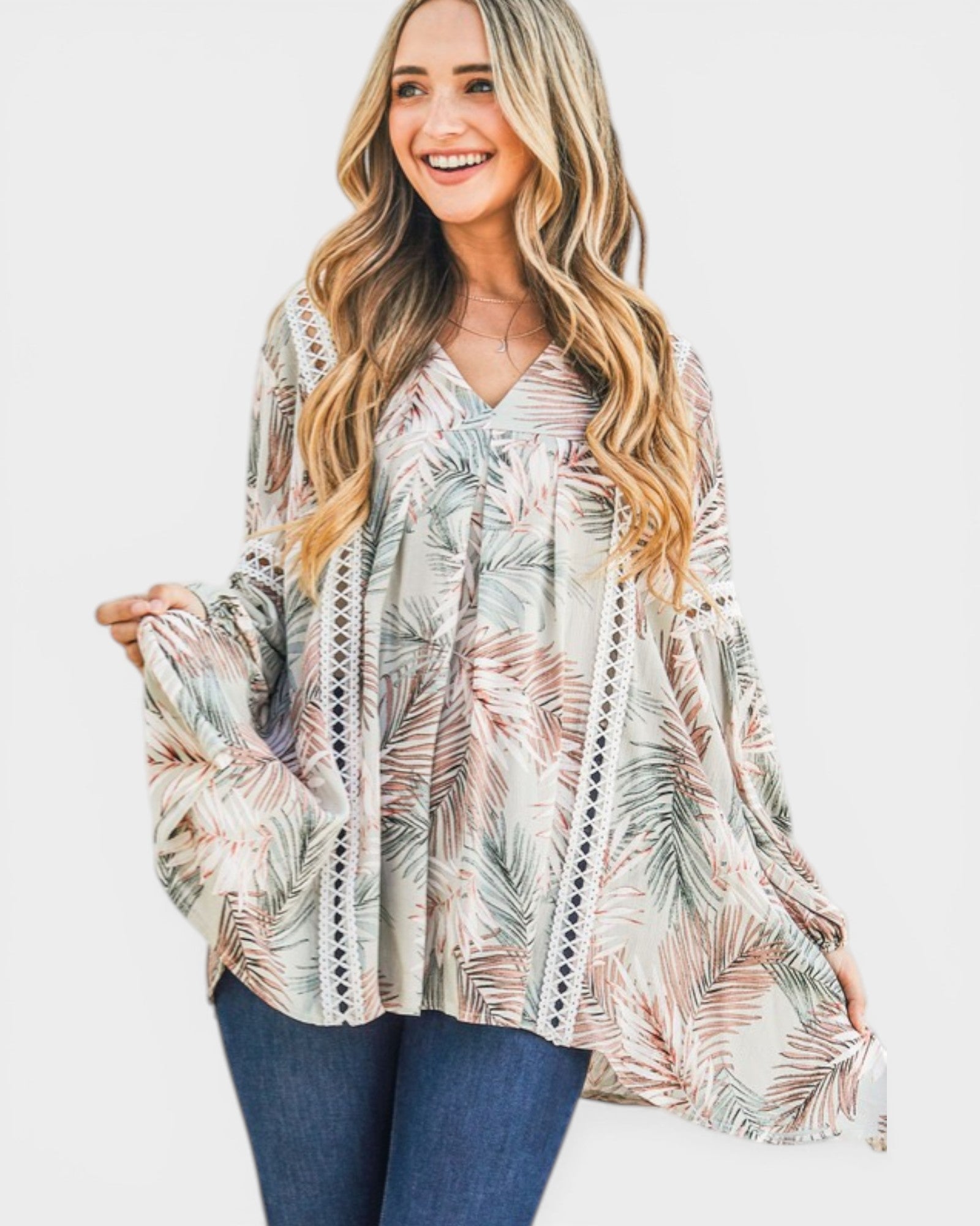 Woman wearing a patterned blouse with long sleeves on a white background