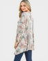 Woman wearing a patterned long-sleeve top on a white background