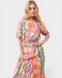 Woman wearing a colorful checkered outfit on a white background