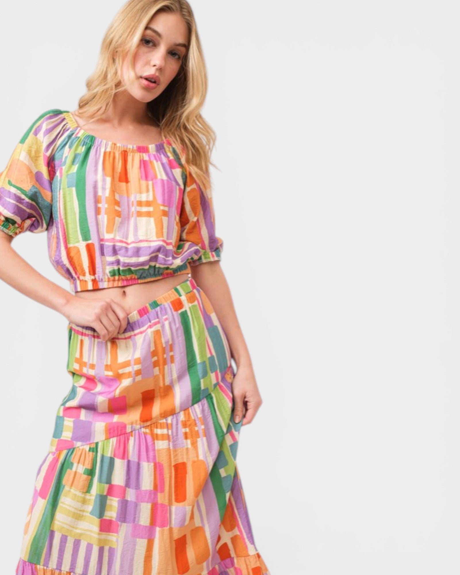 Woman wearing a colorful checkered outfit on a white background