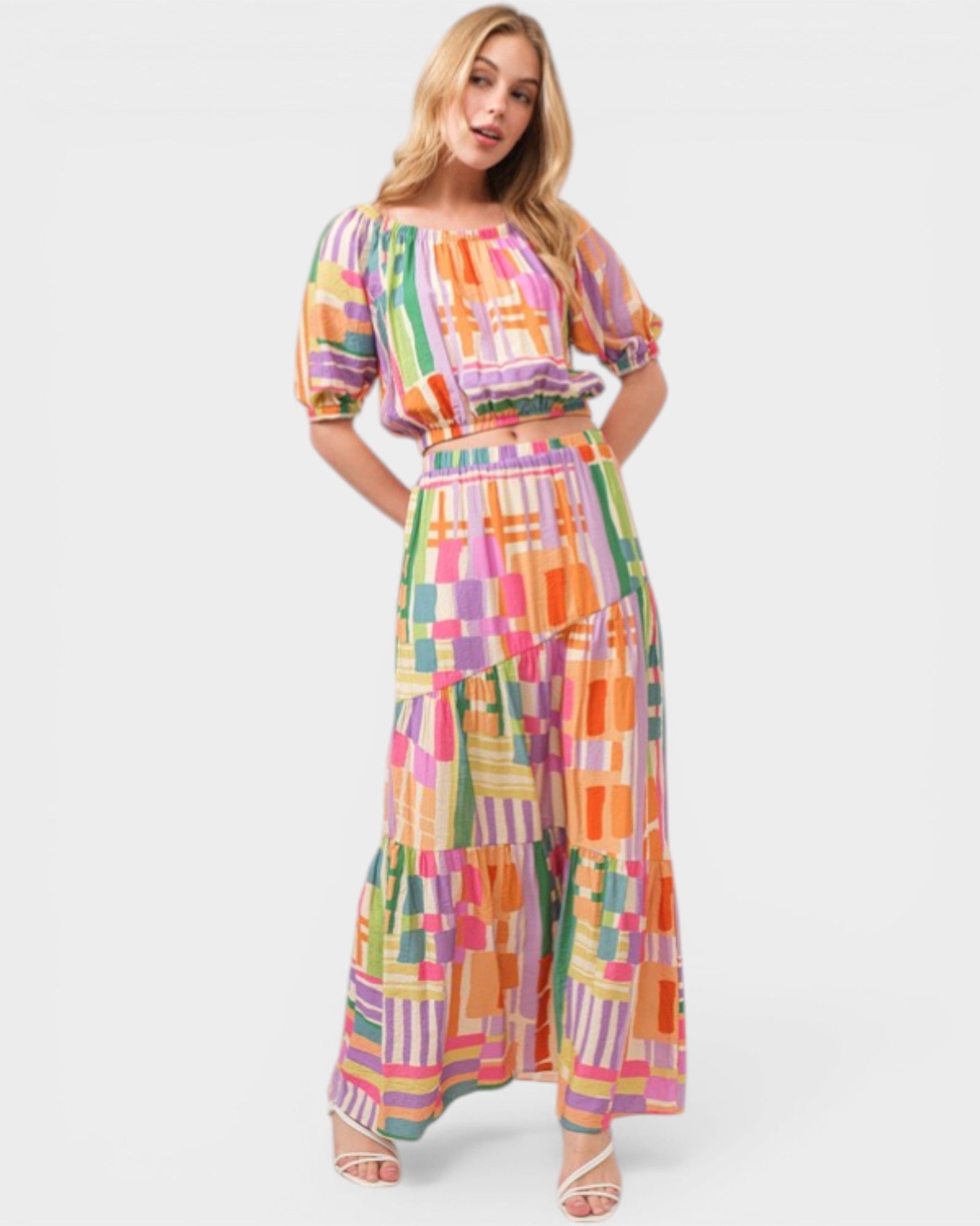 Woman wearing a colorful checkered dress on a white background