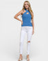 Woman wearing a blue top and white pants on a plain background