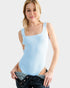 Woman wearing a light blue tank top with a plain background