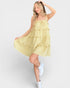 Woman wearing a yellow dress on a white background