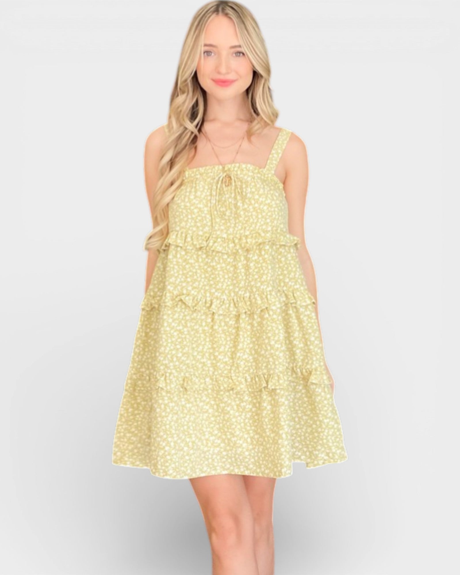 Woman wearing a yellow floral dress on a white background