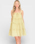 Woman wearing a yellow floral dress on a white background