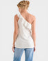 Woman wearing a white one-shoulder top and blue jeans on a white background