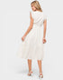 Woman wearing a white dress on a plain background