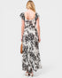 Woman wearing a floral dress with a plain background