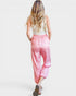 Woman wearing pink leopard print pants on a white background