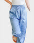 Light blue leopard print pants worn by a person on a white background