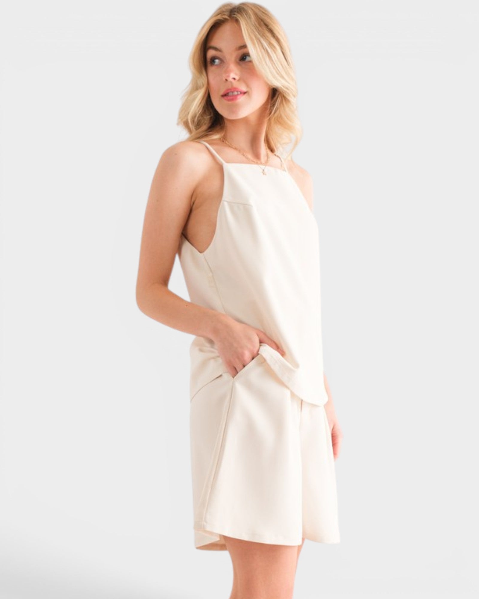 Woman wearing a beige dress on a white background