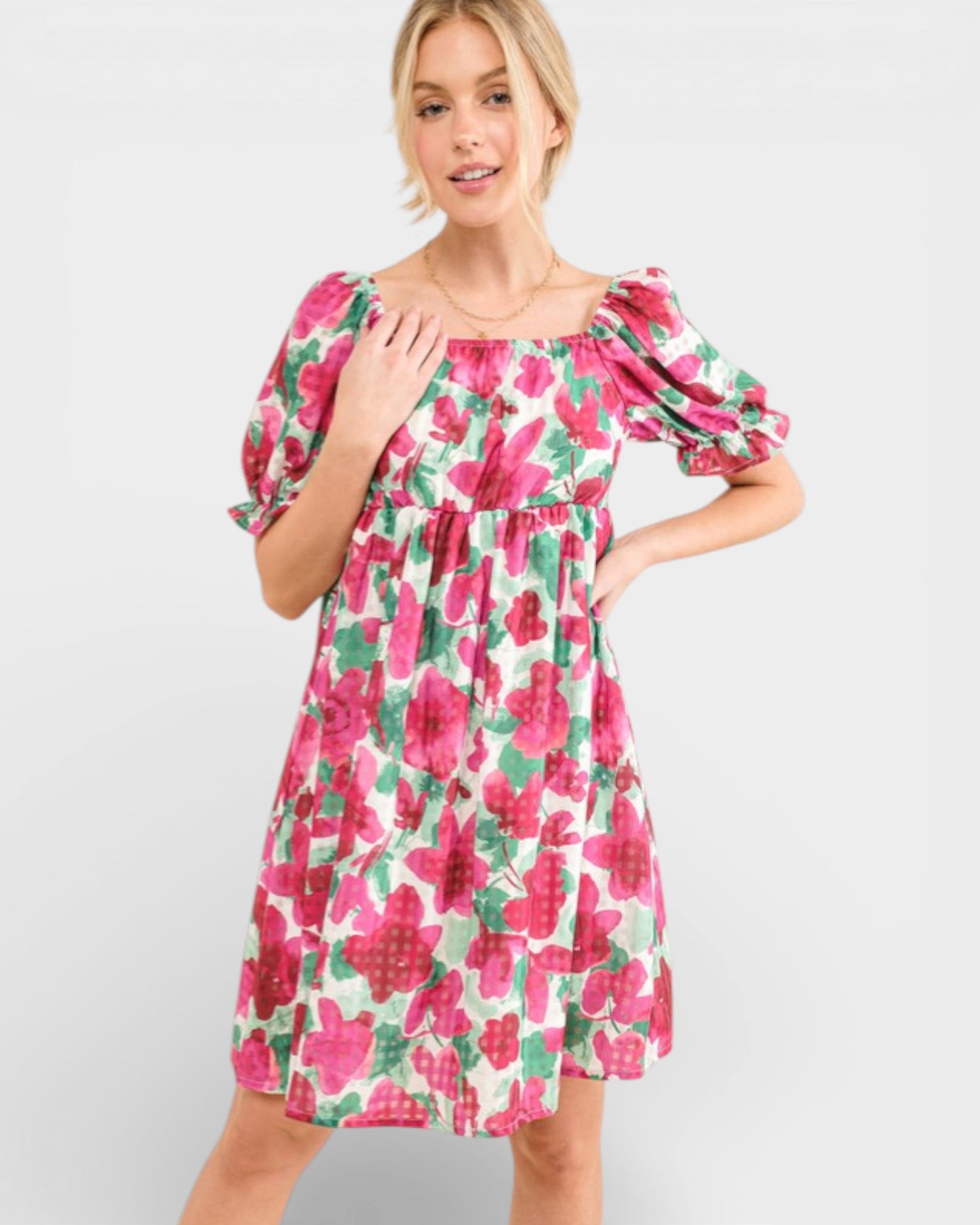 Woman wearing a floral dress on a plain background