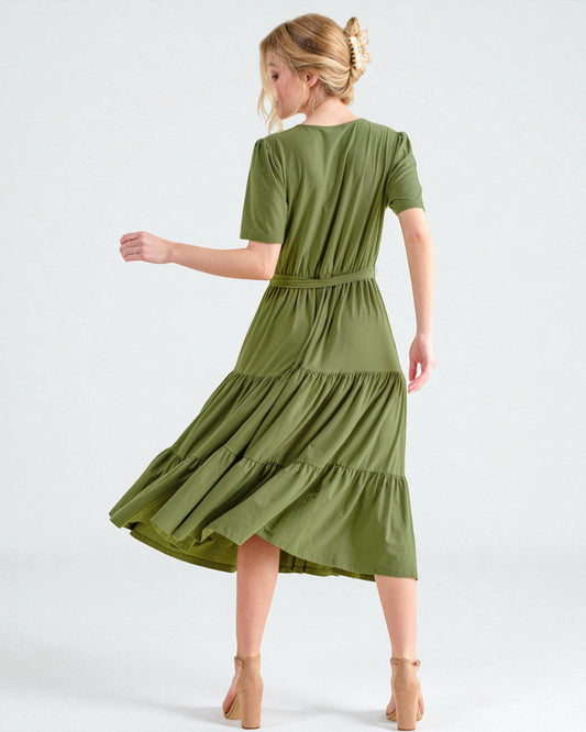 Woman wearing a green dress on a white background