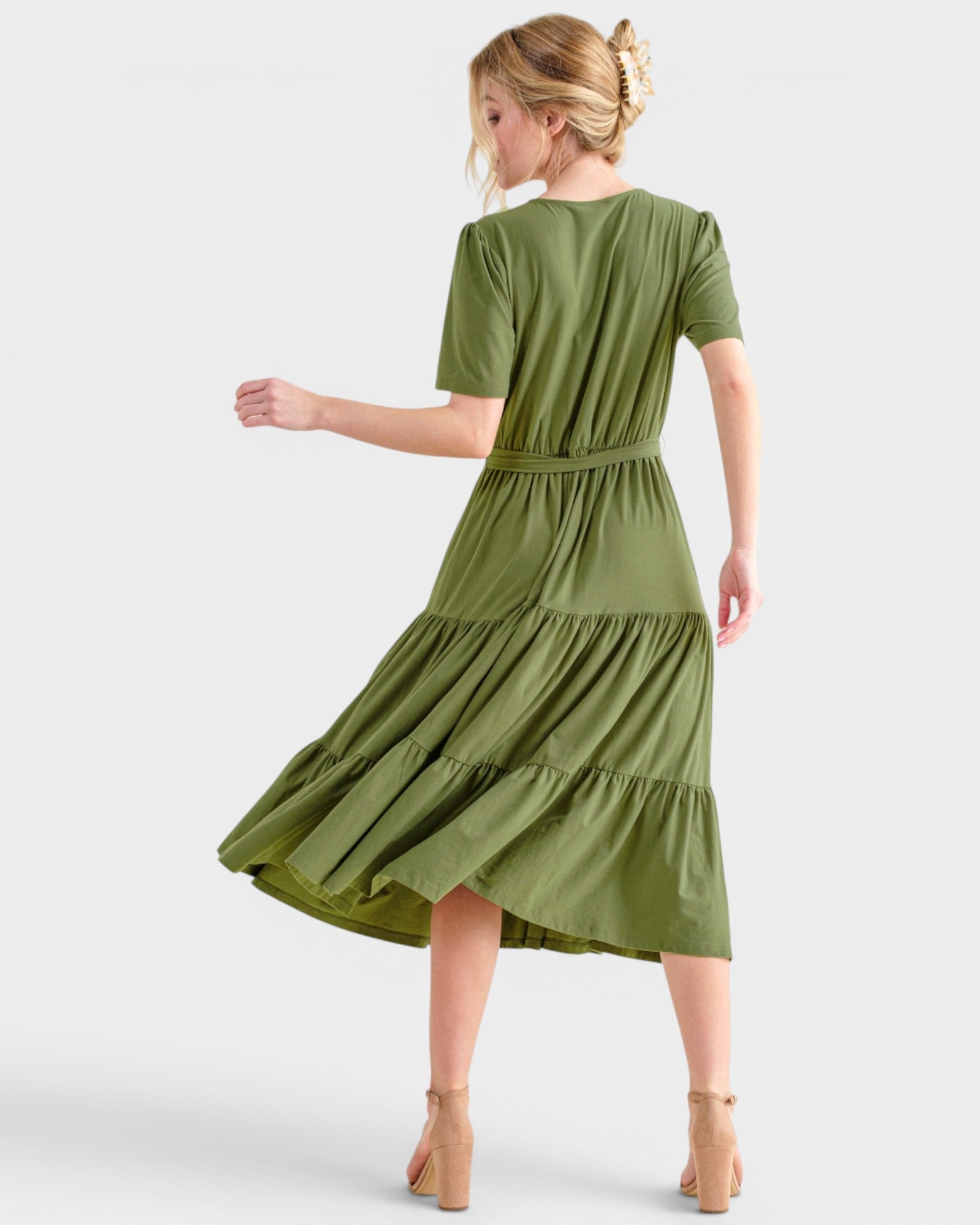 Woman wearing a green dress on a white background