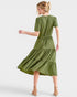 Woman wearing a green dress on a white background