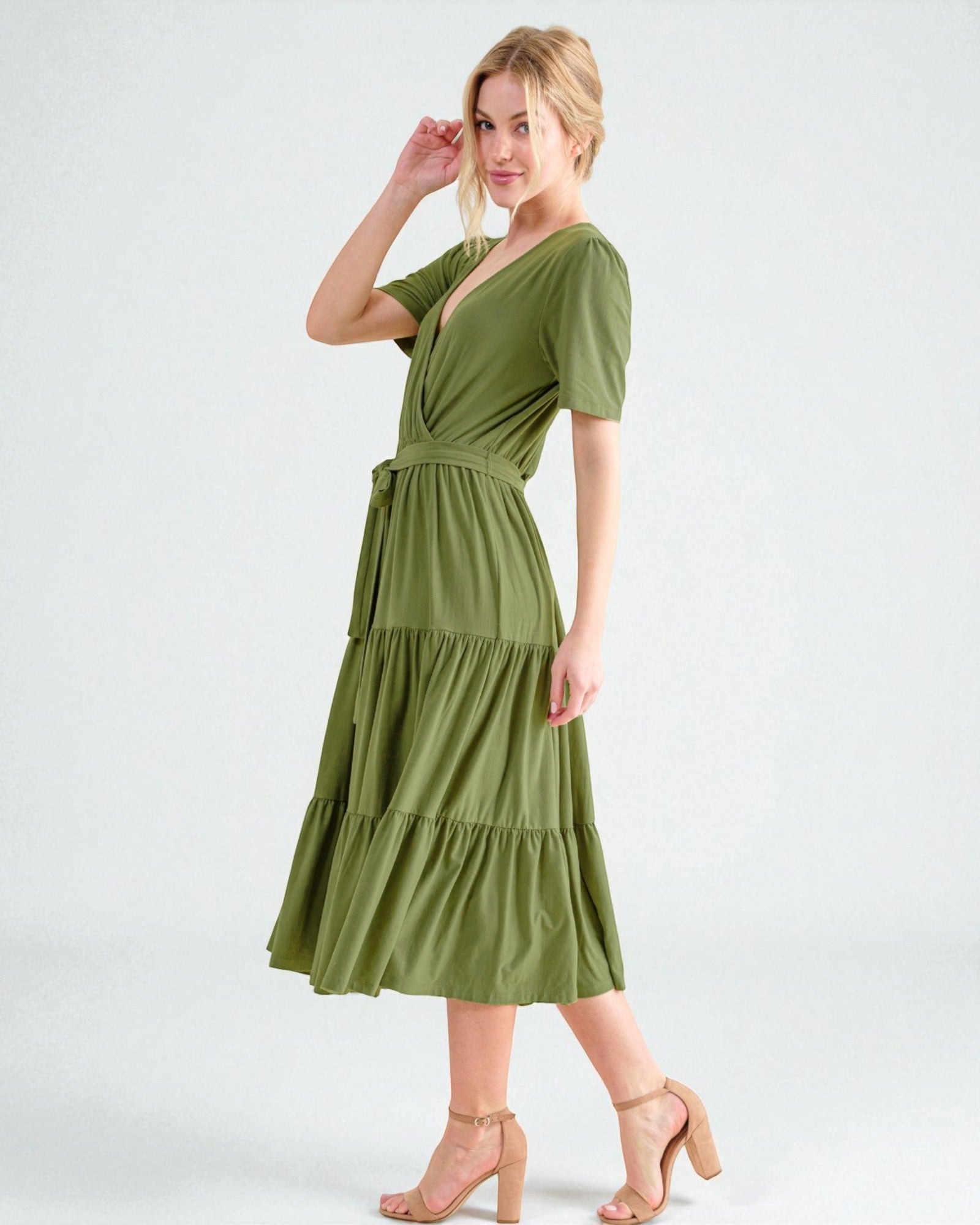 Woman wearing a green dress on a white background