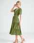 Woman wearing a green dress on a white background