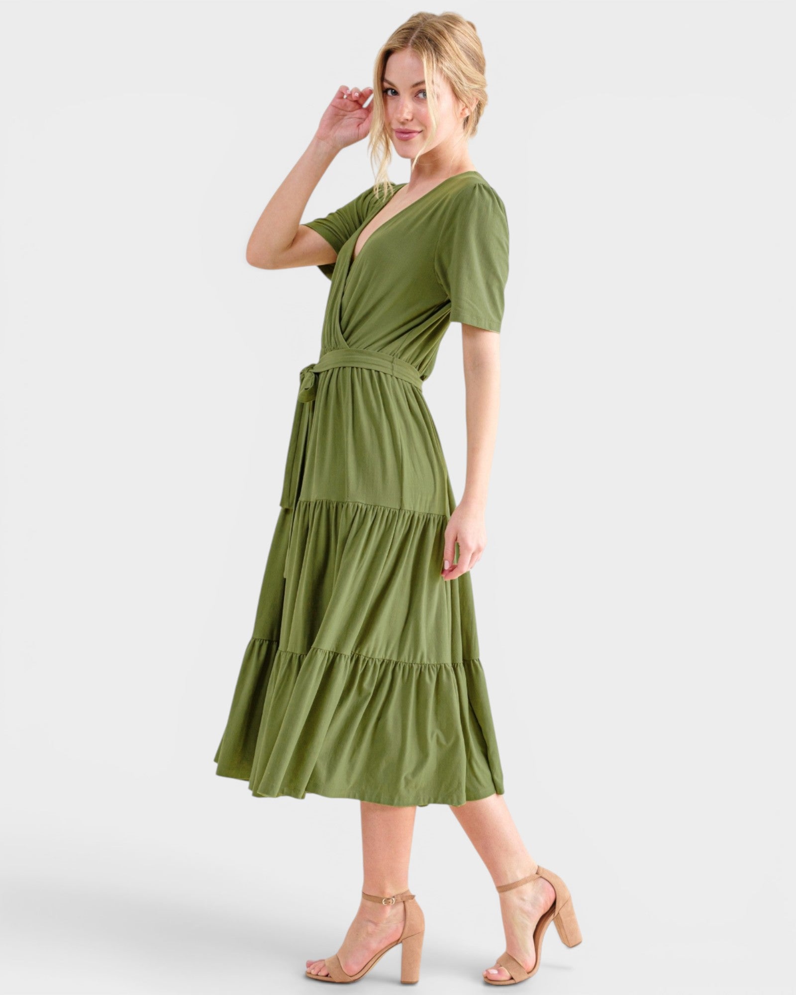 Woman wearing a green dress on a white background