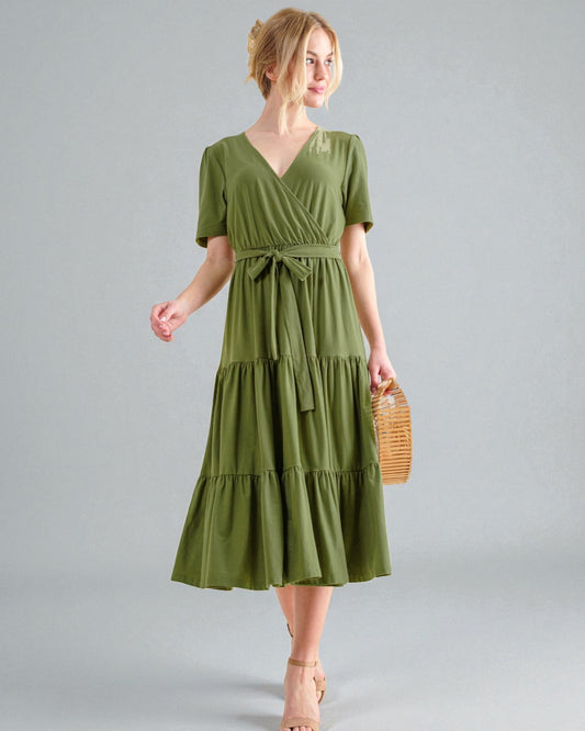 Woman wearing a green dress on a gray background