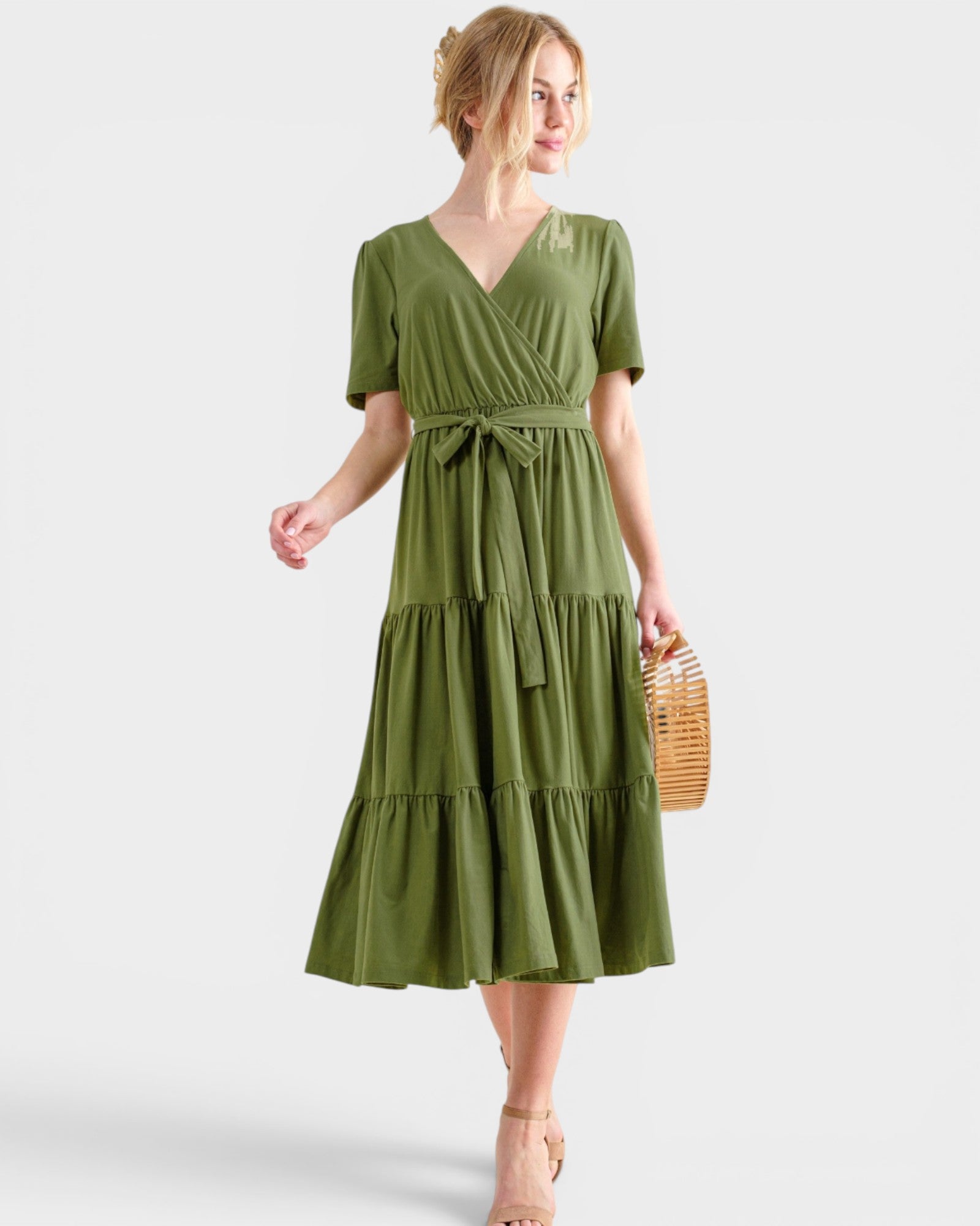 Woman wearing a green dress with a white background
