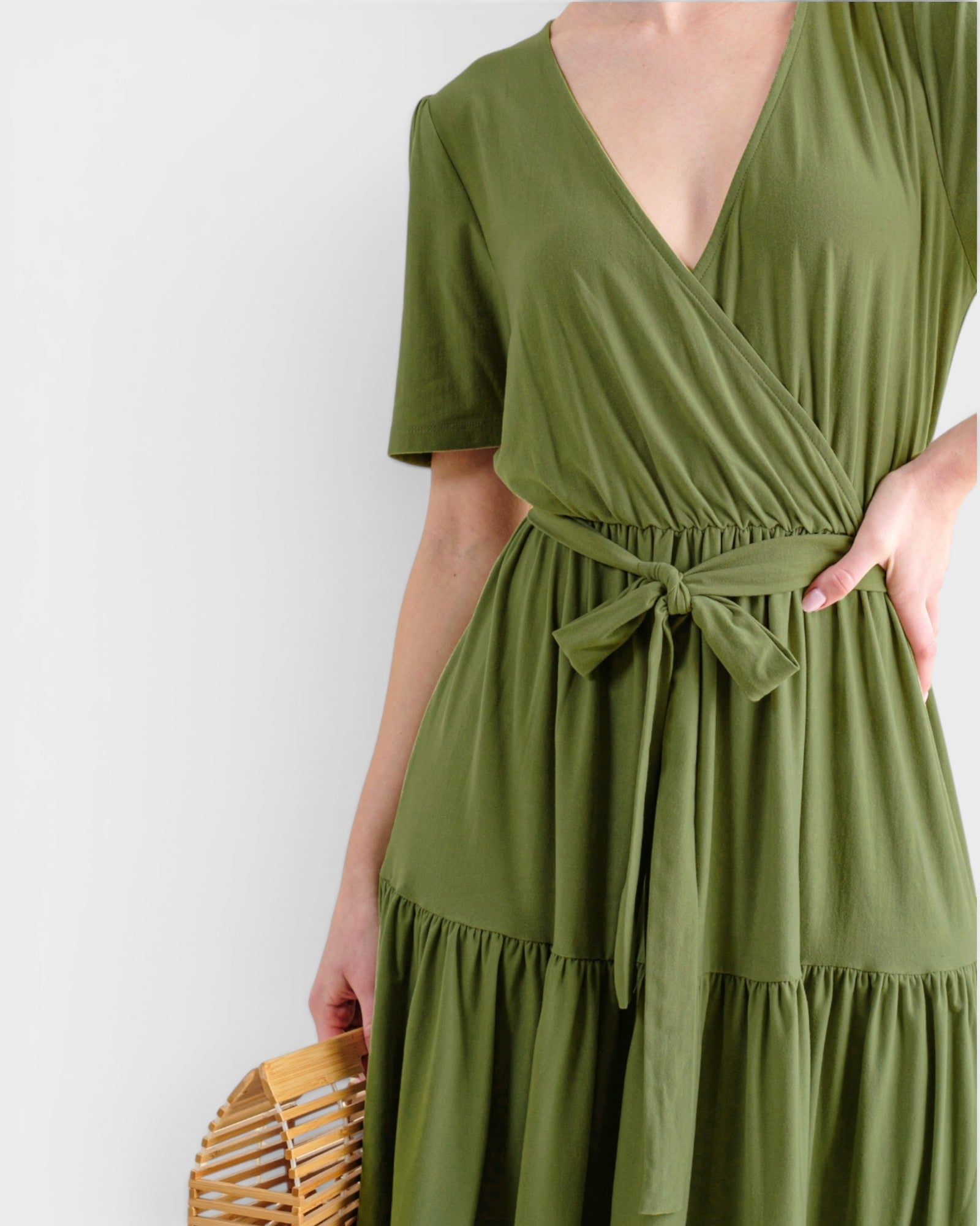 Green dress with a belt on a white background