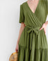 Green dress with a belt on a white background