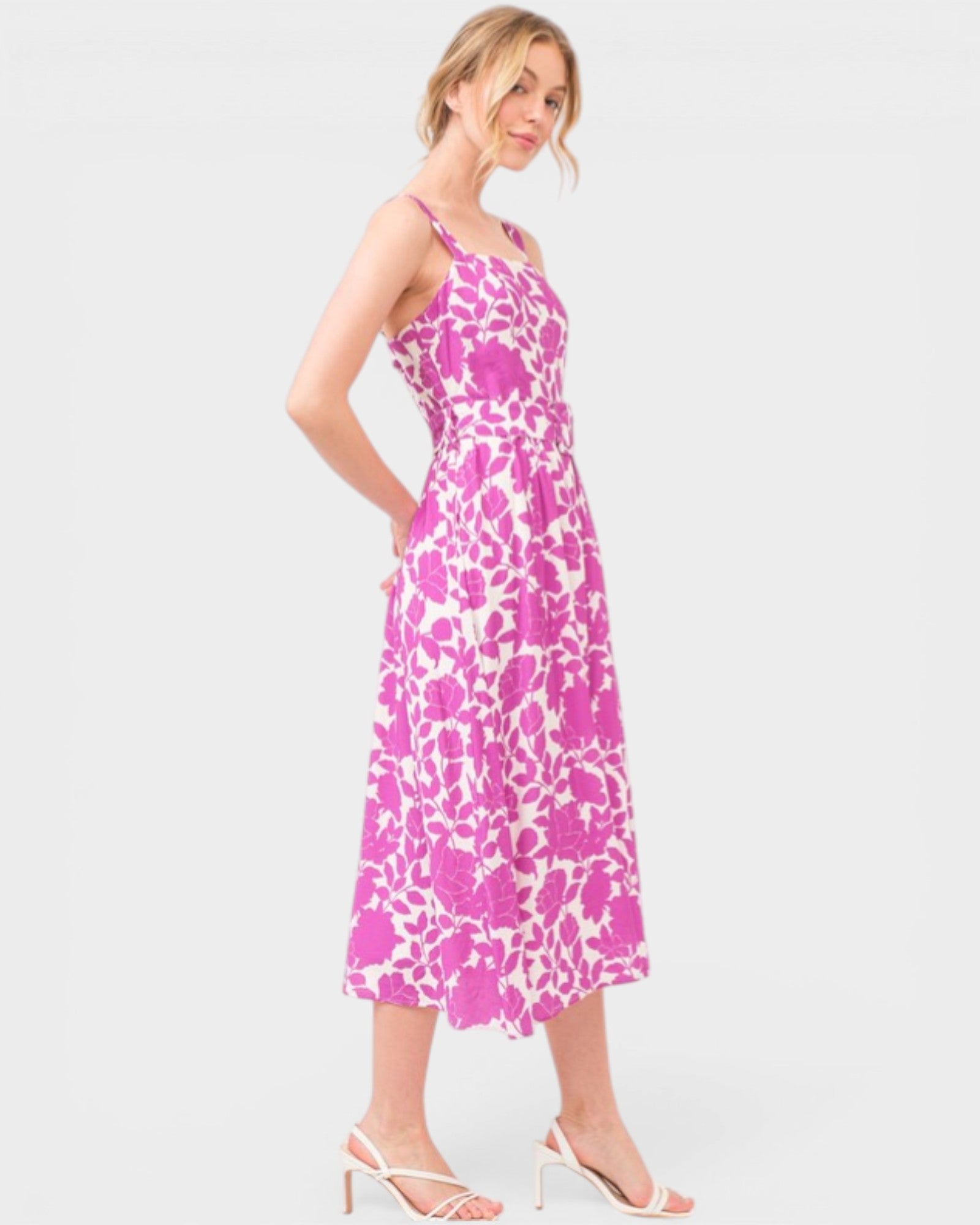 Woman wearing a pink floral dress on a white background