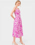 Woman wearing a pink floral dress on a white background