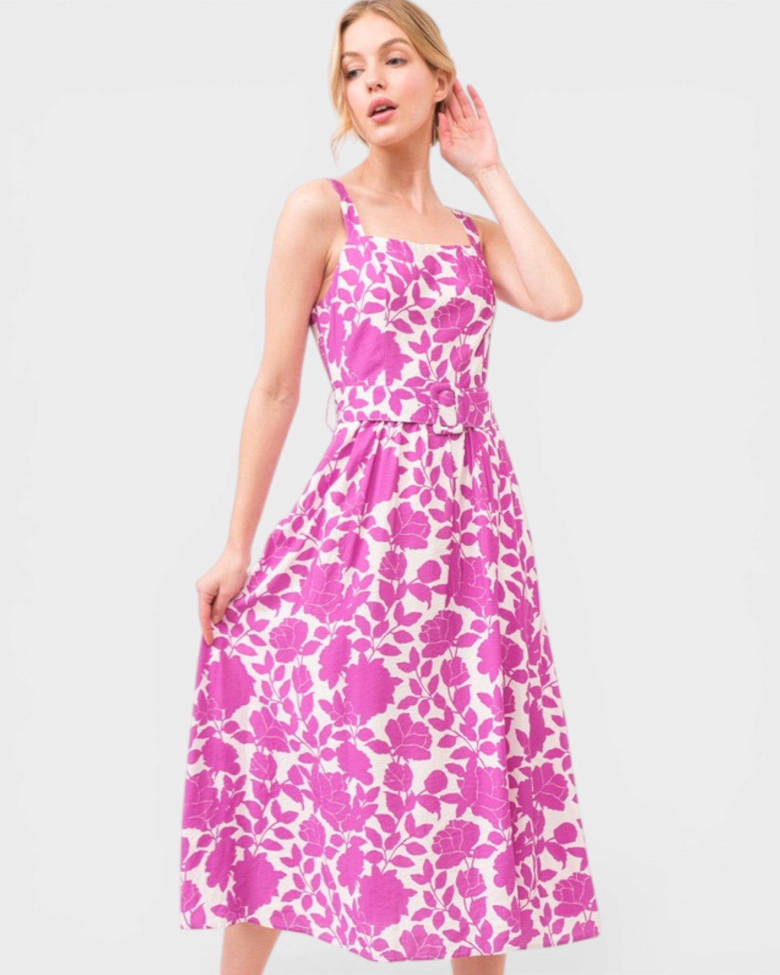 Woman wearing a pink floral dress on a white background