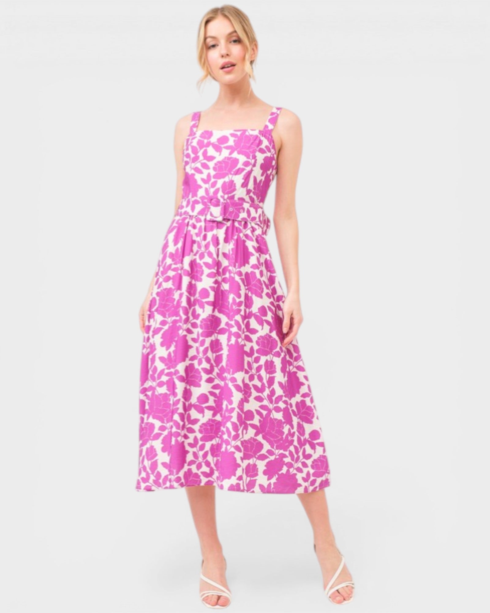 Woman wearing a pink and white patterned dress on a white background