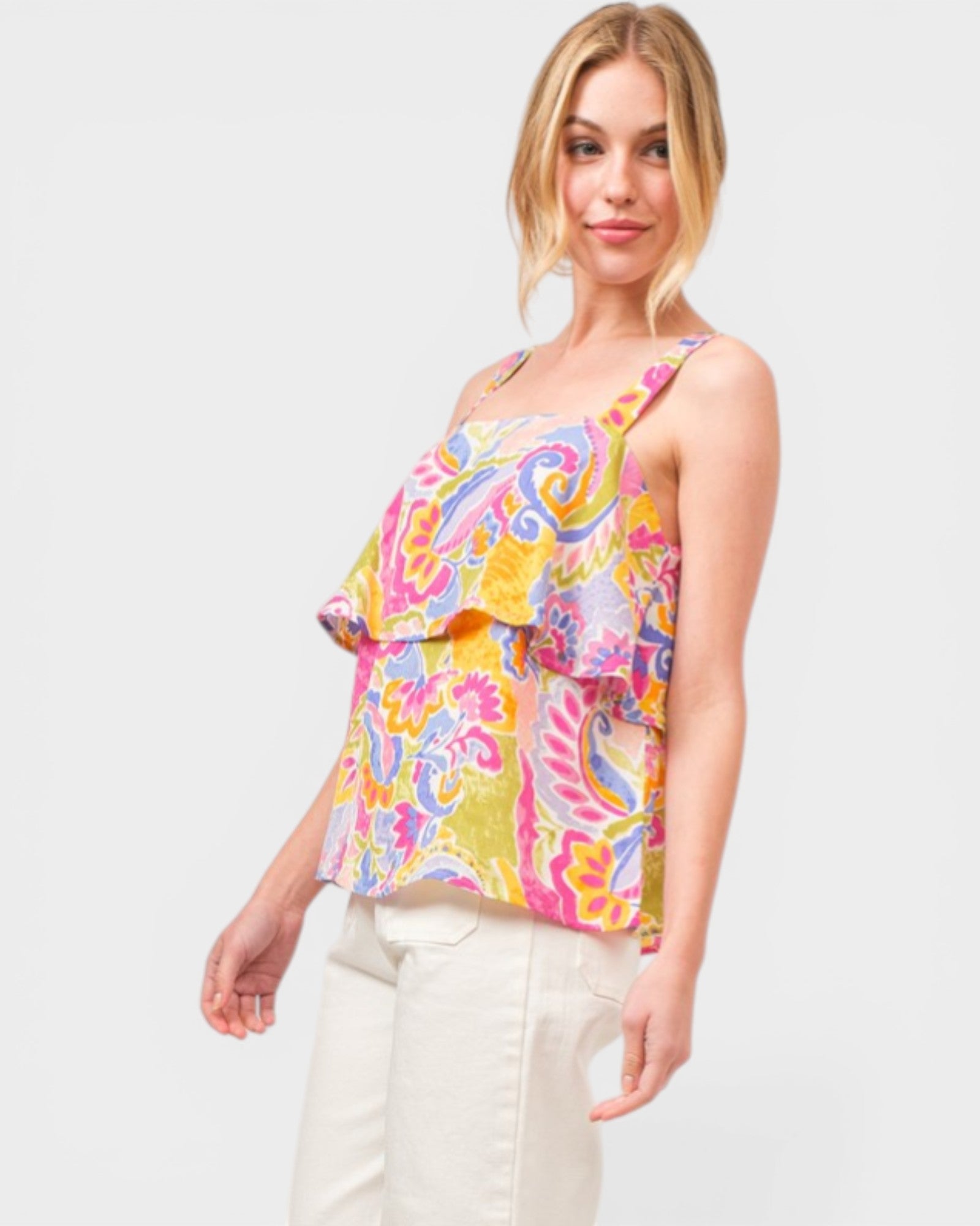 Woman wearing a colorful patterned top on a white background
