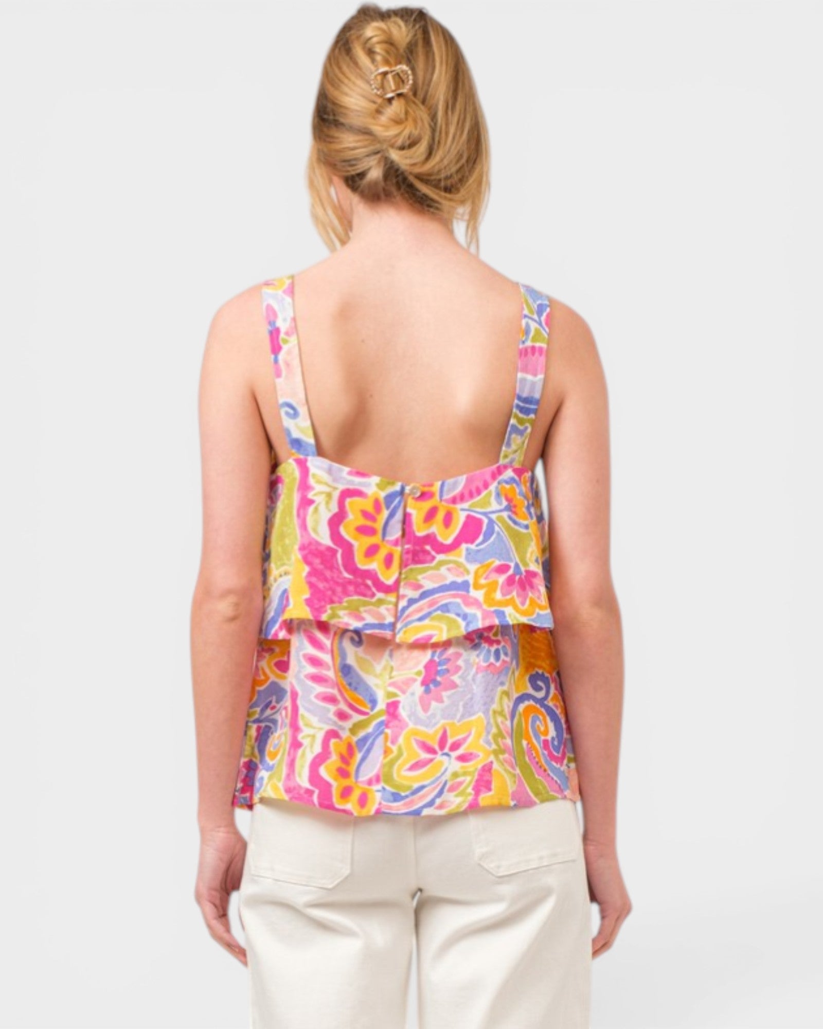 Woman wearing a colorful tank top with a white background