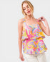 Woman wearing a colorful patterned top on a white background