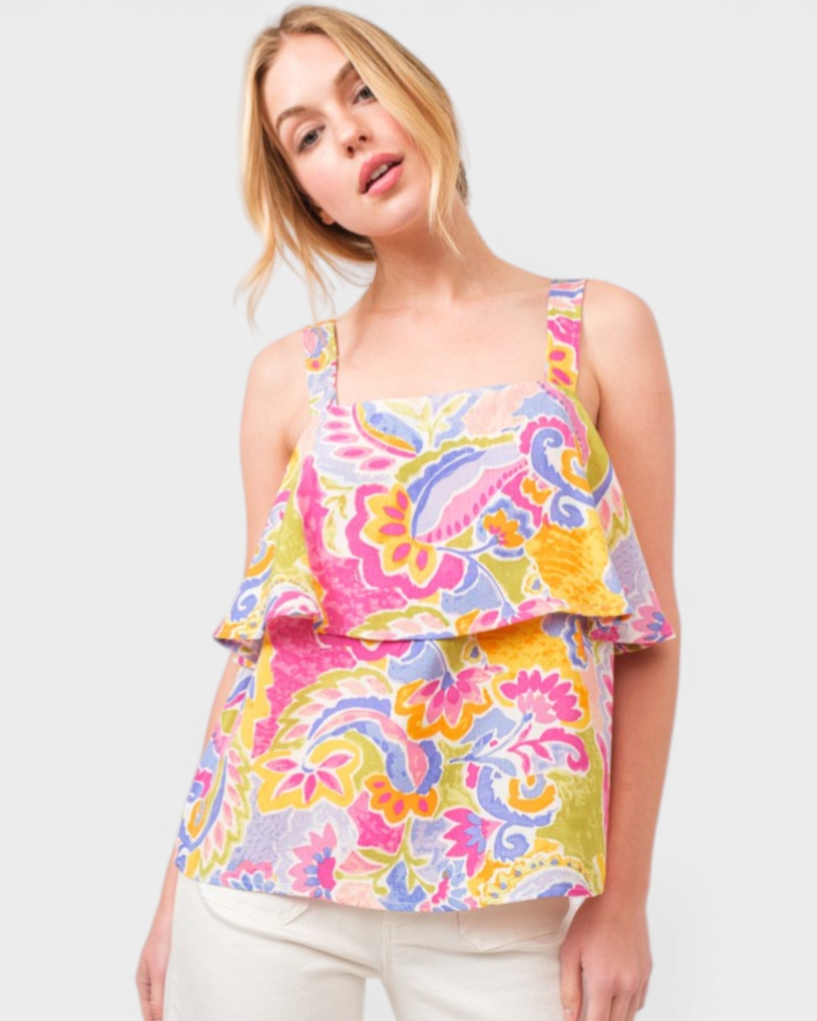 Woman wearing a colorful patterned top on a white background