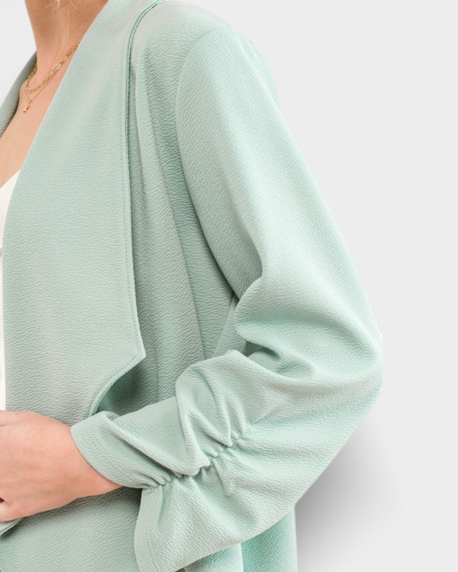 Light green sweater with long sleeves on a white background