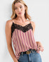 Woman wearing a striped tank top with lace detail and Gucci belt.