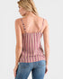 Woman wearing a red and white striped tank top and blue jeans on a light gray background