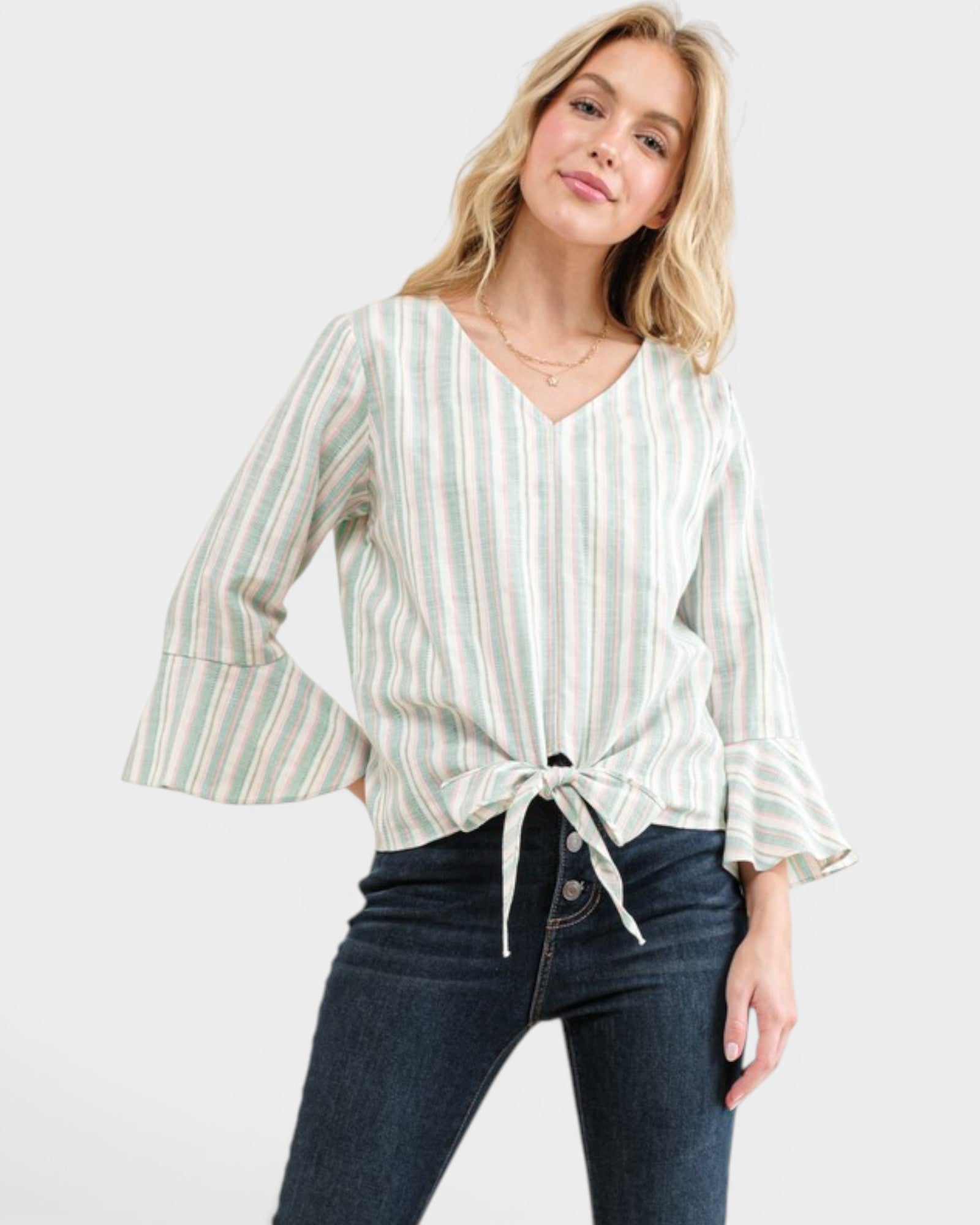 Woman wearing a striped blouse and jeans on a white background